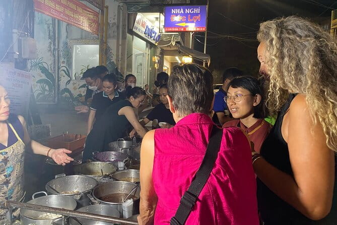 E biking Night Street Food Tour with Local Guide - Eating com hen beside the river