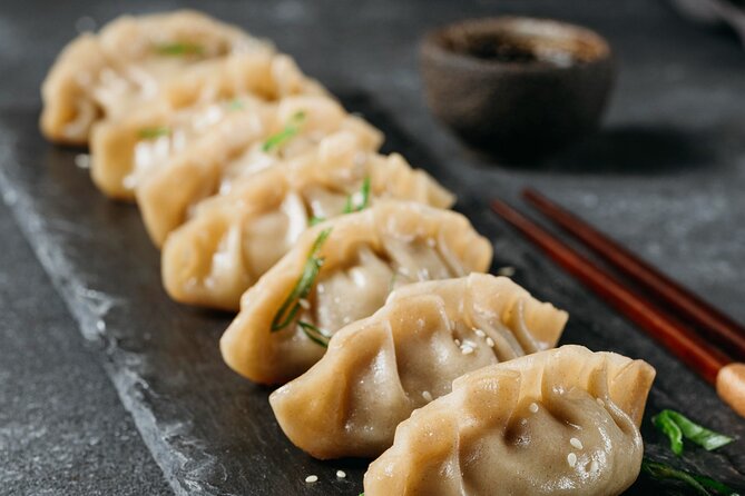 Gyoza Cooking Class in Kyoto: Traditional Japanese Dumplings - Cooking the dumplings with a professional machine