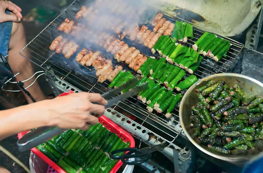 Saigon: Best Price Authentic Walking Street Food Tour - Bánh khọt and the art of wrapping food
