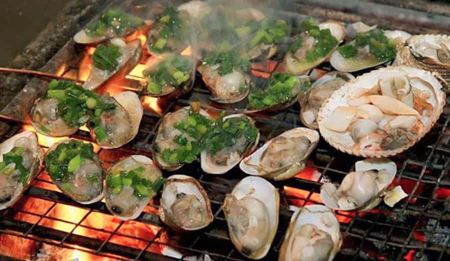 Saigon: Best Price Authentic Walking Street Food Tour - Bánh mì, grilled oysters, and local snacks