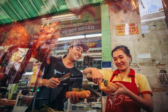 Saigon Night Bites on Foot: Local Vendors, Stories & Sweet Finish - Walking past Chùa Bà Thiên Hậu and Ong Lanh Bridge Market