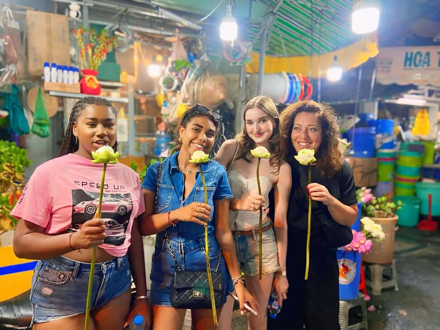 Saigon: Street Food Tasting & Sightseeing Tour by Motorbike - Flower stalls, Cambodian market food, and small savory bites