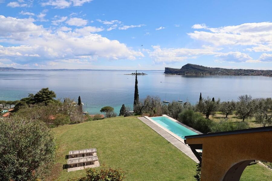 San Felice: Olive Oil Tasting with local food on Garda Hills - Walking through the grove with Rocca di Manerba in view